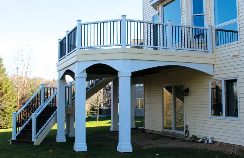 Elegant white columns with decorative arched brackets on curved elevated deck