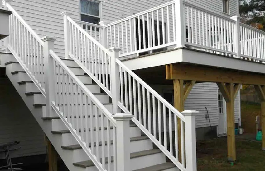 Multi-level deck stair system with white railings providing access to different deck levels