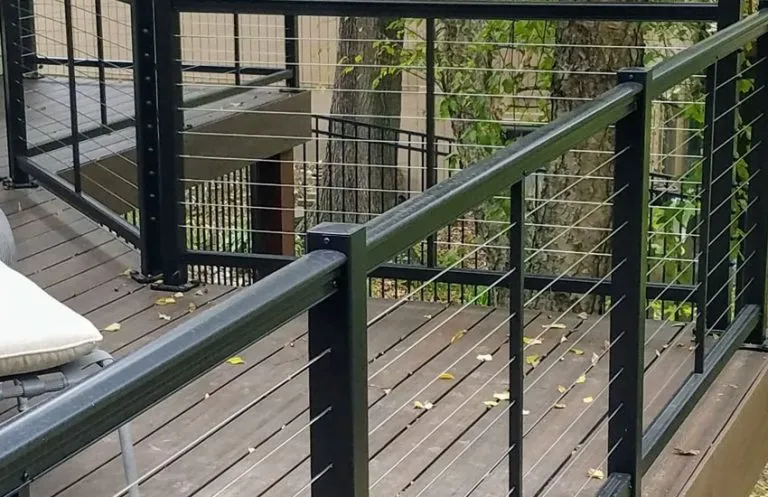 Black aluminum posts with horizontal stainless steel cable railing on composite deck