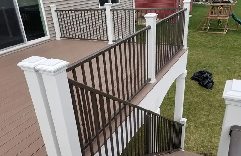 White composite posts with bronze aluminum balusters on elevated deck
